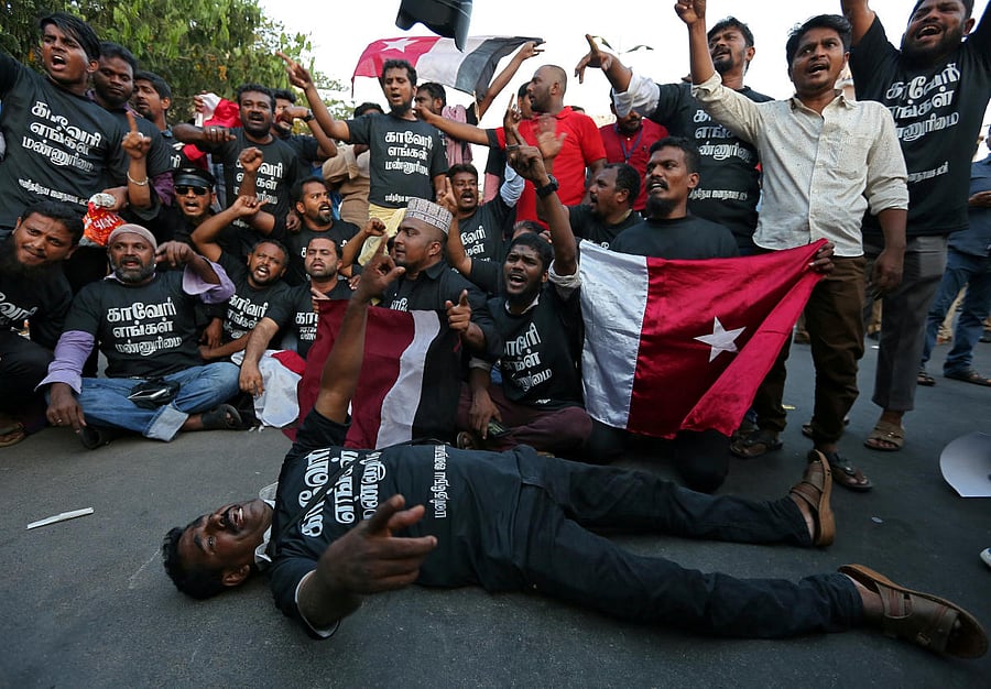 Demonstrators shout slogans as they block a road outside the Chidambaram Stadium ahead of the clash between CSK and KKR. REUTERS