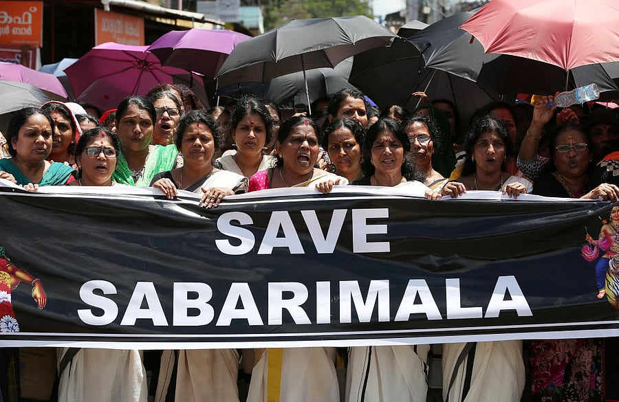 Women chant hymns during a protest called by various Hindu organisations against the lifting of ban by Supreme Court that allowed entry of women of menstruating age to the Sabarimala temple, on the outskirts of Kochi. Reuters Photo