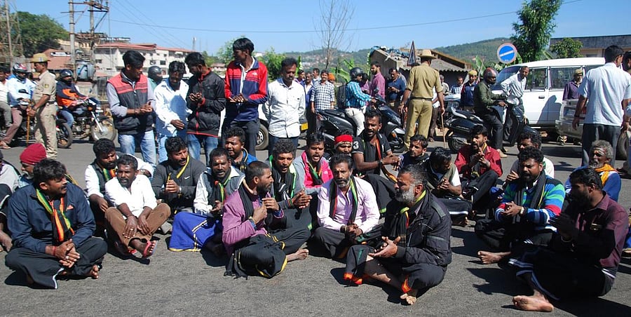 Devotees of Lord Ayyappa stage a protest condemning the entry of women into Sabarimala shrine, at General Thimmaiah Circle in Madikeri on Thursday.