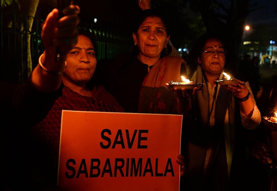 Devotees participate in a candlelight vigil to protest against the Supreme Court's order revoking the traditional ban on the entry of women aged between 10 to 50 years inside the Sabarimala temple, in New Delhi on January 21, 2019. AFP