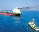 Italian cargo ship M V Enrica Lexie, in the background, anchored off Kochi on Thursday. Indian Coast Guard Ship Lakshmi Bai is seen in the foreground. AP/Indian Navy