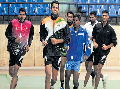 CARRYING HOME-HOPES: Karnataka volleyball team skipper A Karthik (in front) and team-mates warm-up during a practice session at the Sree Kanteerava stadium in Bengaluru on Friday. DH PHOTO