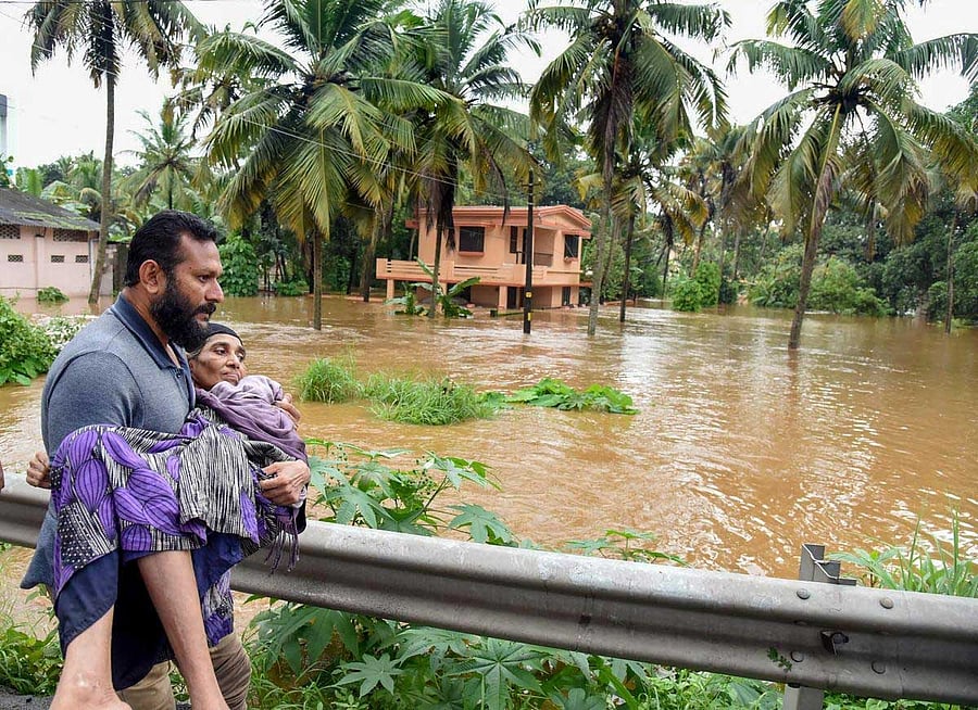 People being rescued from a flood-affected region following heavy monsoon rainfall, in Kochi on Thursday. PTI Photo