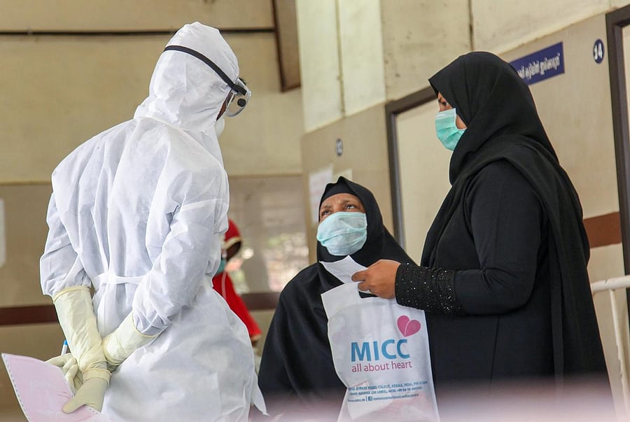 Doctors and patients wear safety masks as a precautionary measure after the Nipah virus outbreak, at a medical college in Kozhikode, Kerala. PTI FILE