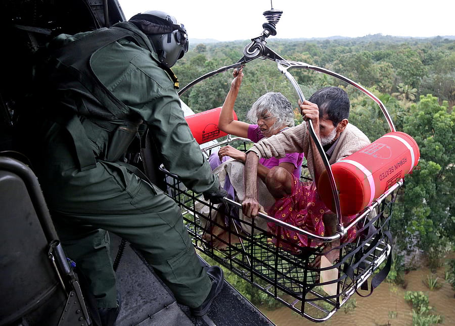 People are airlifted by the Indian Navy soldiers during a rescue operation at a flooded area in Kerala. REUTERS