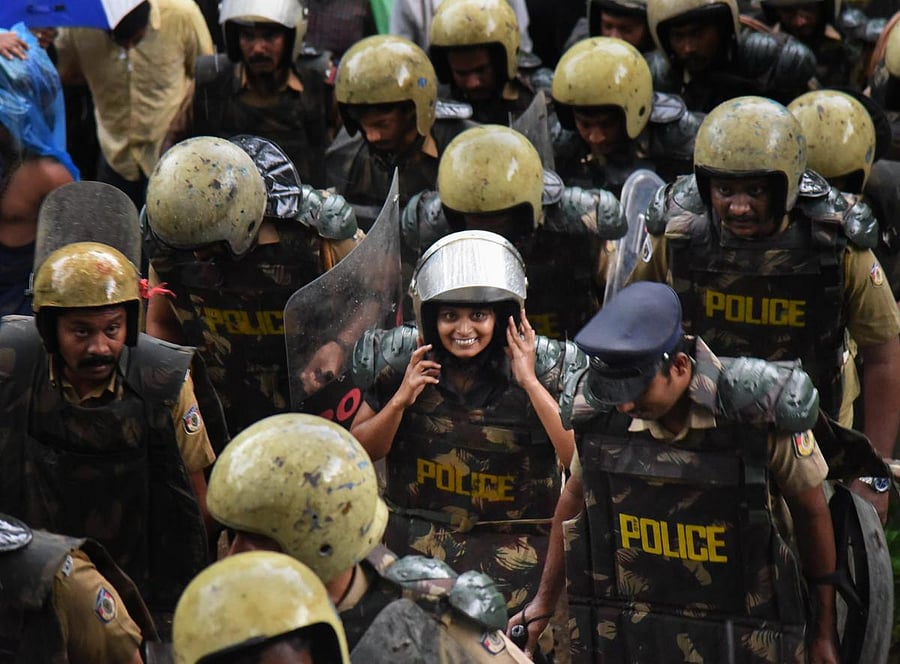 Journalist Kavitha Jakkal being escorted by the police to Sabarimala Temple in Kerala on Friday. PTI photo