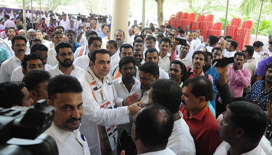Congress workers greet Congress-JD(S) candidate Pramod Madhwaraj during his visit to Congress office in Udupi on Monday. 