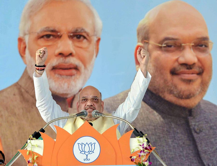 BJP National President Amit Shah gestures as he addresses a state-level party workers meeting at BHEL Dussehra ground in Bhopal on Friday. PTI Photo