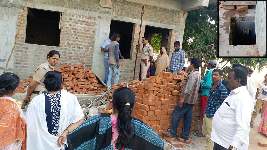 Police at the construction site where the incident occurred. (inset) The sump where the two children drowned.