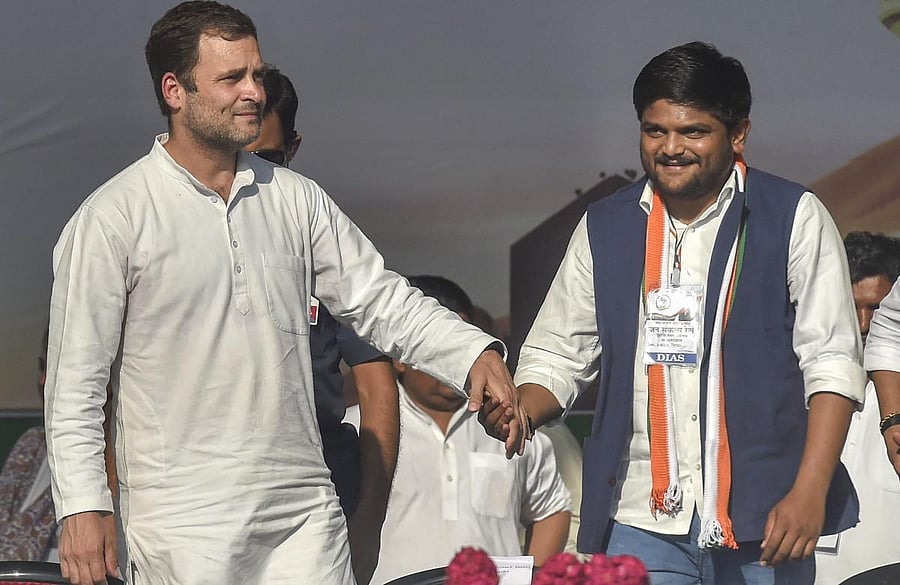 Patidar leader Hardik Patel with Congress president Rahul Gandhi as he joins the Congress, during a public meeting in Gandhinagar on March 12, 2019. (PTI Photo)