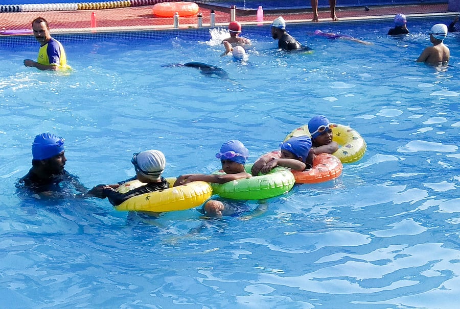 Children are enjoying the water in a summing pool , To beat the heat, in Bengaluru on Monday. Photo/ B H Shivakumar