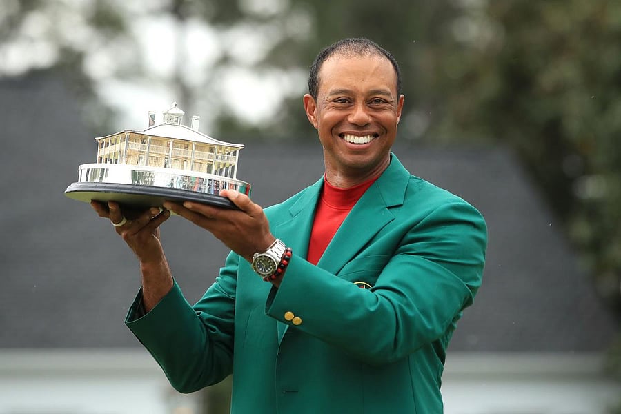 Tiger Woods is all smiles holding the Masters Trophy after scoring a sensational one-stroke win on Sunday. AFP