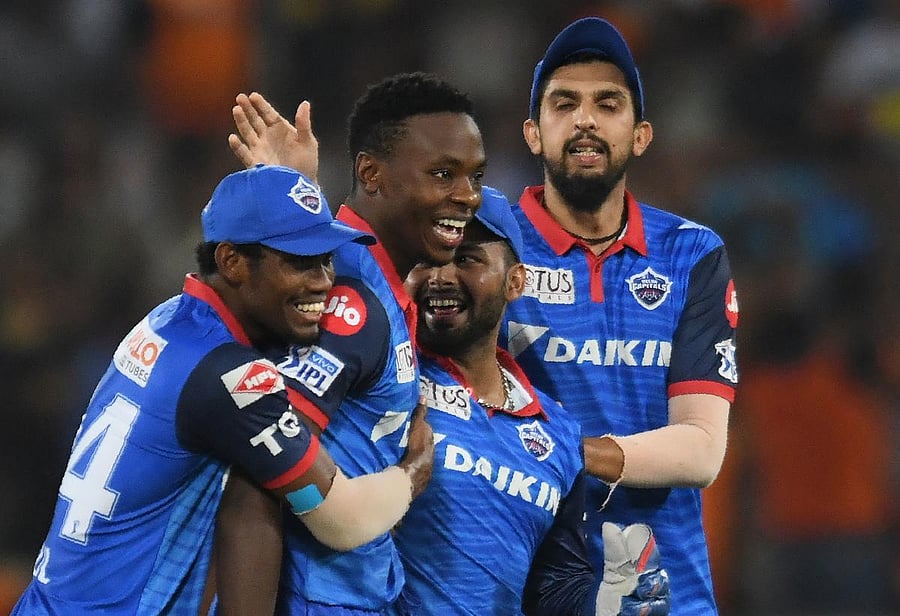 Delhi Capitals' Kagiso Rabada (2L) celebrates with teammates after taking the wicket of Sunrisers Hyderabad batsman David Warner. AFP