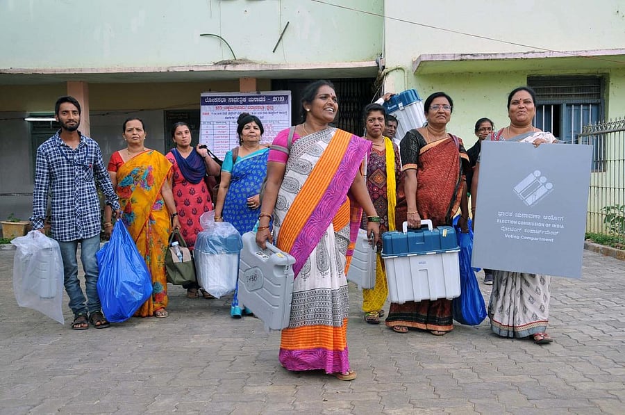 The polling personnel leave with the ballot unit and control unit from the mustering centre in Chikkamagaluru.