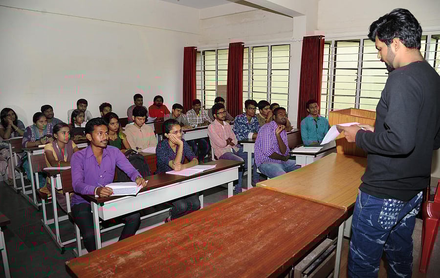 Indian woman at a business meeting, giving a presentation.Education - university