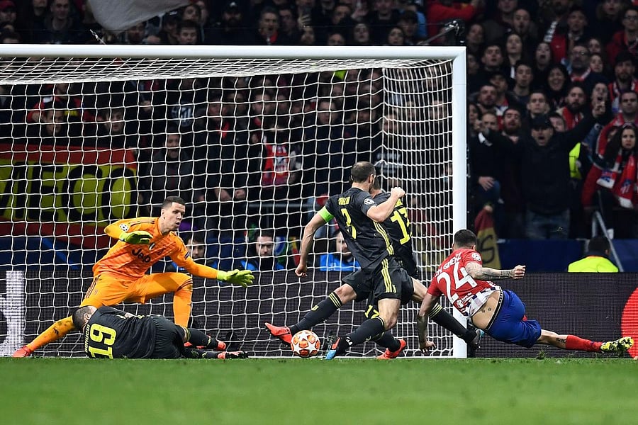 Atletico Madrid's Jose Gimenez (right) scores the opening goal against Juventus on Wednesday. AFP