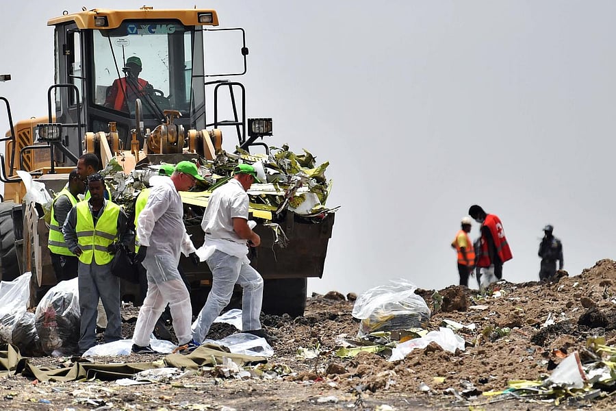 Forensics workers comb through the debris at the crash site of the Ethiopian Airlines operated Boeing 737 MAX aircraft, at Hama Quntushele village in Oromia region. AFP photo