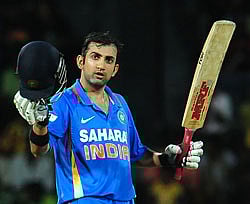 Gautam Gambhir raises his bat and helmet in celebration after scoring a century during the third one day international (ODI) match between Sri Lanka and India at the R. Premadasa Cricket Stadium in Colombo on Saturday. AFP