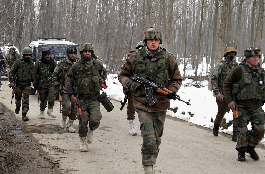 Army soldiers move towards the house where militants were hiding during an encounter in Ratnipora area of Pulwama district of south Kashmir on Feb 12, 2019. PTI