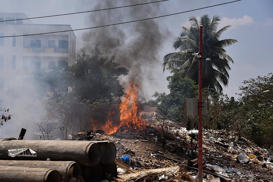 Some one putted fire to Garbage in Banaswadi Double Main Road, Subbaiahna Palya, near Fire Station, Banaswadi in Bengaluru on Tuesday. BBMP Fixed CC tv camera but it is not affect the people, Fire polluted air and near Petrol bunk is there, one spark burn