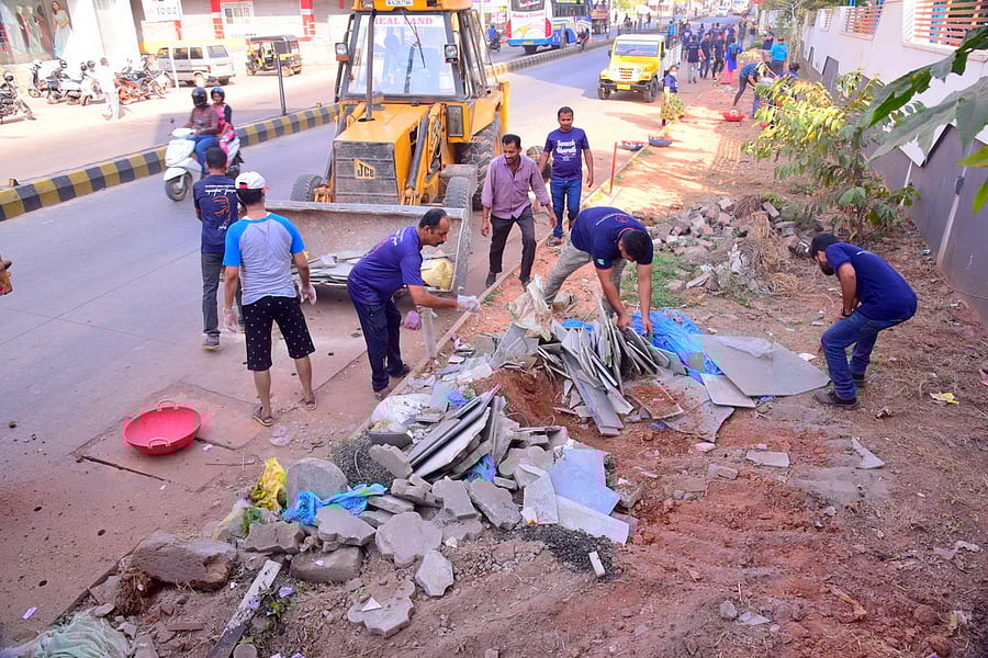 Volunteers clean the debris at Bendoorwell area in Mangaluru.