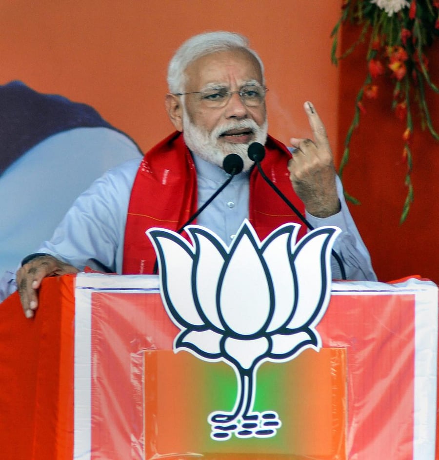 Kendrapara: Prime Minister Narendra Modi shows his finger marked with indelible ink as he addresses 'Vijay Sankalp Sabha', party's election meeting in support of BJP's Kendrapada candidate Baijayant Panda ahead of the fourth phase Lok Sabha elections, in