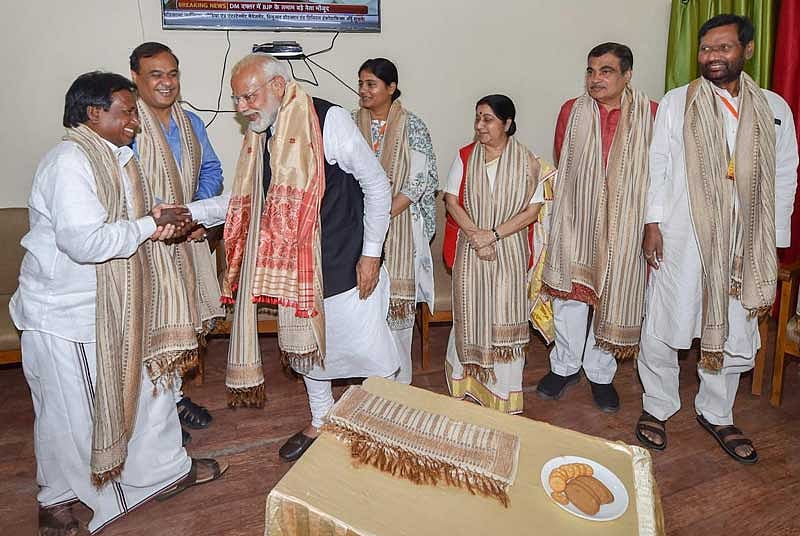 Prime Minister Narendra Modi greets AIADMK's P Venugopal as other NDA leaders look on, ahead of filing his nomination papers for Lok Sabha polls, in Varanasi. (PTI Photo)