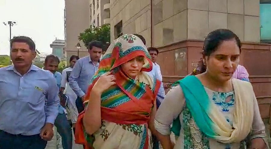Apoorva Shukla Tiwari, accused of murdering her husband Rohit Shekhar Tiwari, being taken away after she was produced in a court in New Delhi. (PTI Photo)
