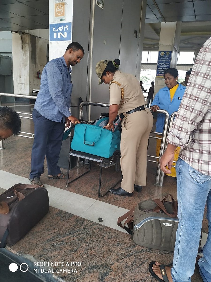 Police manually checking the baggage in KSRTC bus stand.