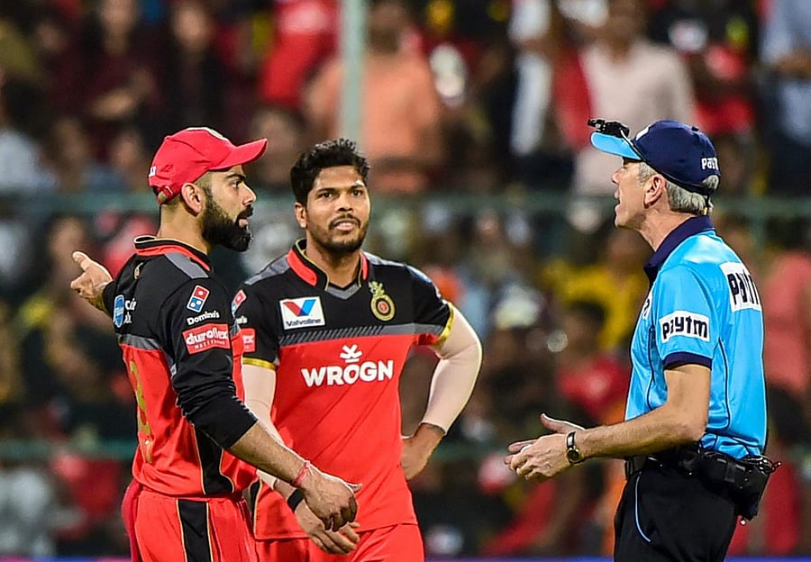 RCB captain Virat Kohli has a word with umpire Nigel Llong after he wrongly adjudged a Umesh Yadav delivery as no-ball. PTI
