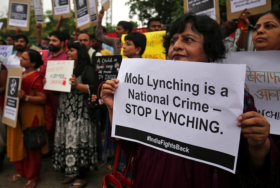 FILE PHOTO: People shout anti-government slogans during a protest against what the demonstrators say are recent mob lynchings across the country, in Ahmedabad, India, July 23, 2018. REUTERS/Amit Dave/File photo