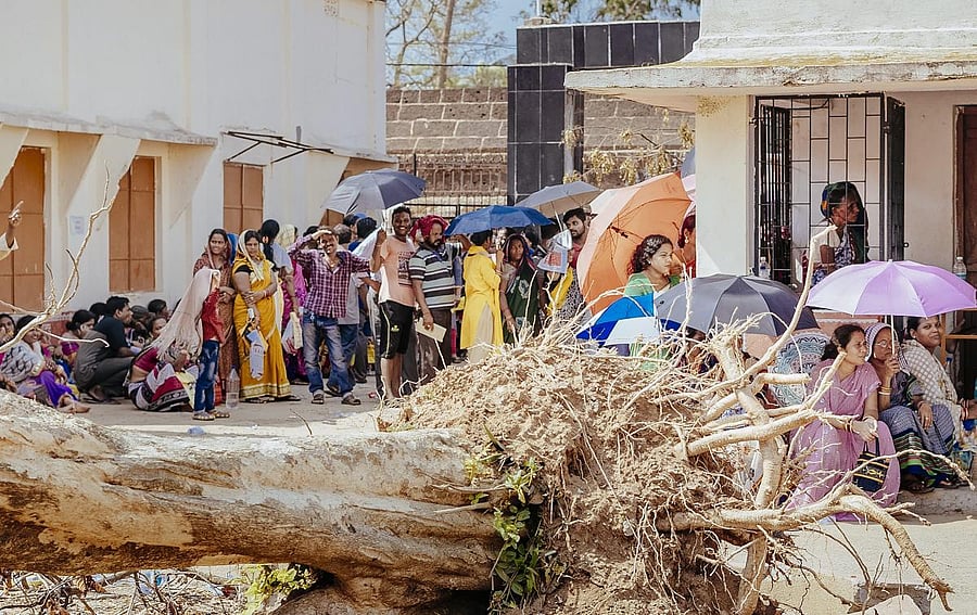 Cyclone Fani affected people wait to receive relief material being distributed by the Odisha government, in Bhubaneswar, Saturday, May 11, 2019. (PTI Photo)