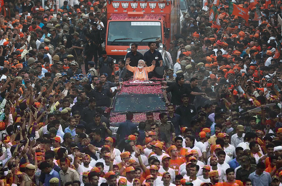 Prime Minister Narendra Modi waves towards his supporters during a roadshow in Varanasi, April 25, 2019. REUTERS