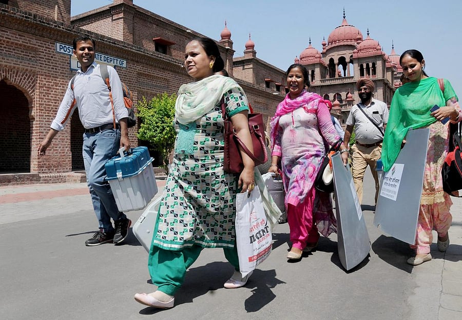 Election officials carry EVM and VVPAT machines and other equipments ahead of the seventh and last phase of Lok Sabha polls. (Photo PTI)