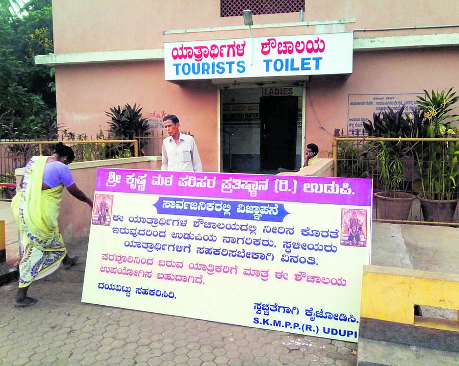 A board placed near tourist toilet asking local residents not to use it.