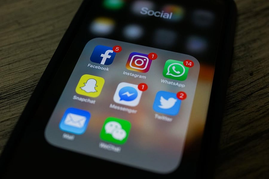 This photo illustration shows apps for Facebook, Instagram, Twitter and other social networks on a smartphone. (Photo by AFP PHOTO)