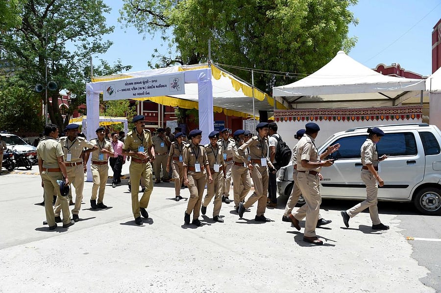 State police officials walk in the premises at a counting centre on the eve of vote counting day of India's general election (Photo AFP)