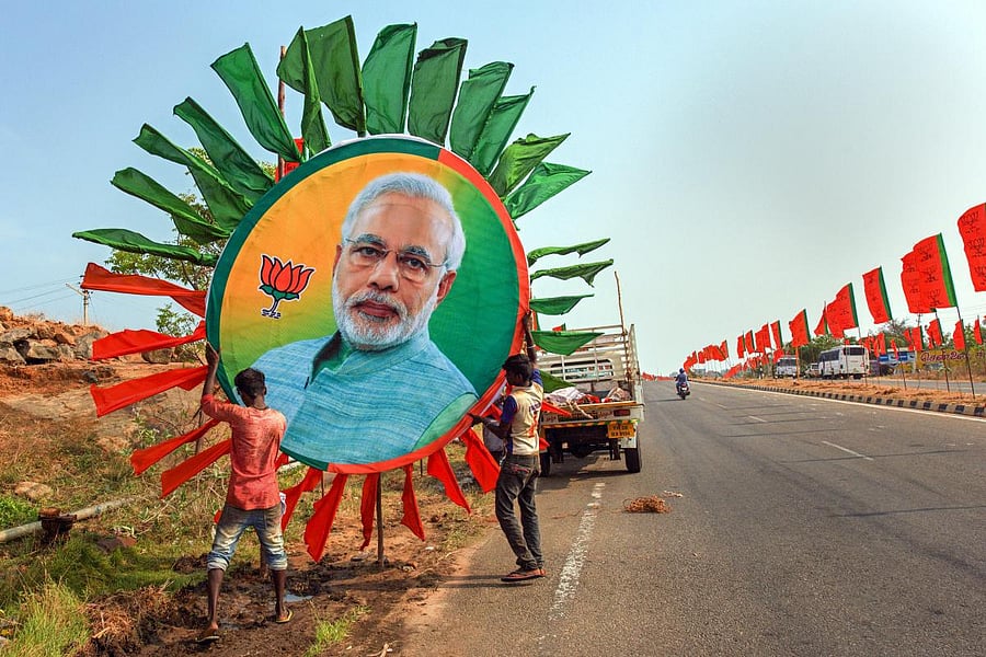 Kanyakumari: Workers place a huge portrait of Prime Minister Narendra Modi along a road ahead of his rally, in Kanyakumari, Thursday, Feb. 28, 2019. (PTI Photo)