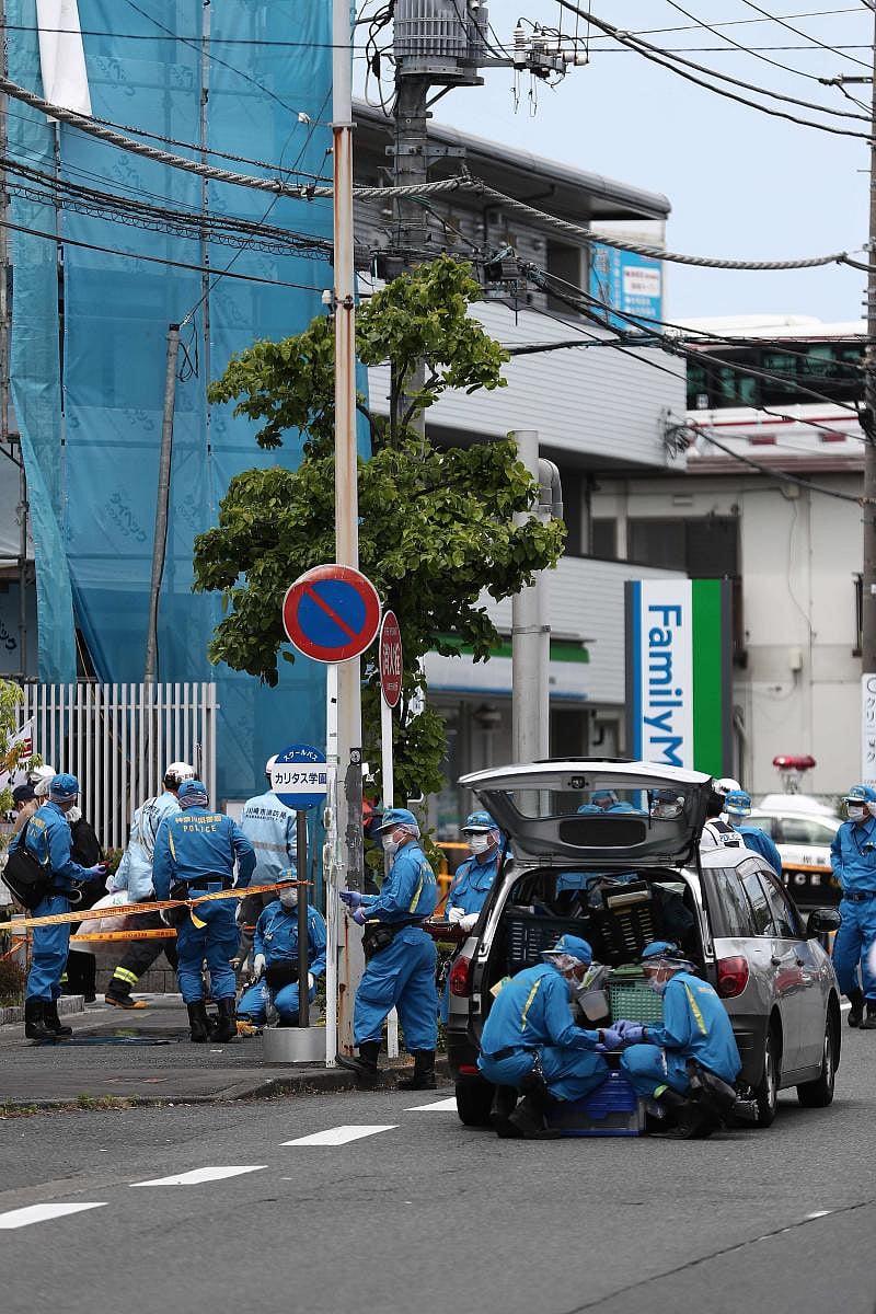 Police forensic experts are seen at the crime scene where a man stabbed 19 people, including children in Kawasaki on May 28, 2019. - Two people, including a child, were feared dead in a mass stabbing attack that also injured 17 people in the Japanese city