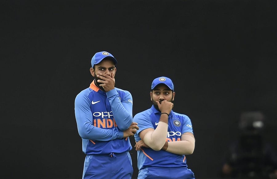 Indian cricket team captain Virat Kohli with teammate Rohit Sharma during their 5th ODI match, at Feroz Shah Kotla Cricket Stadium in New Delhi on Wednesday. (PTI Photo)