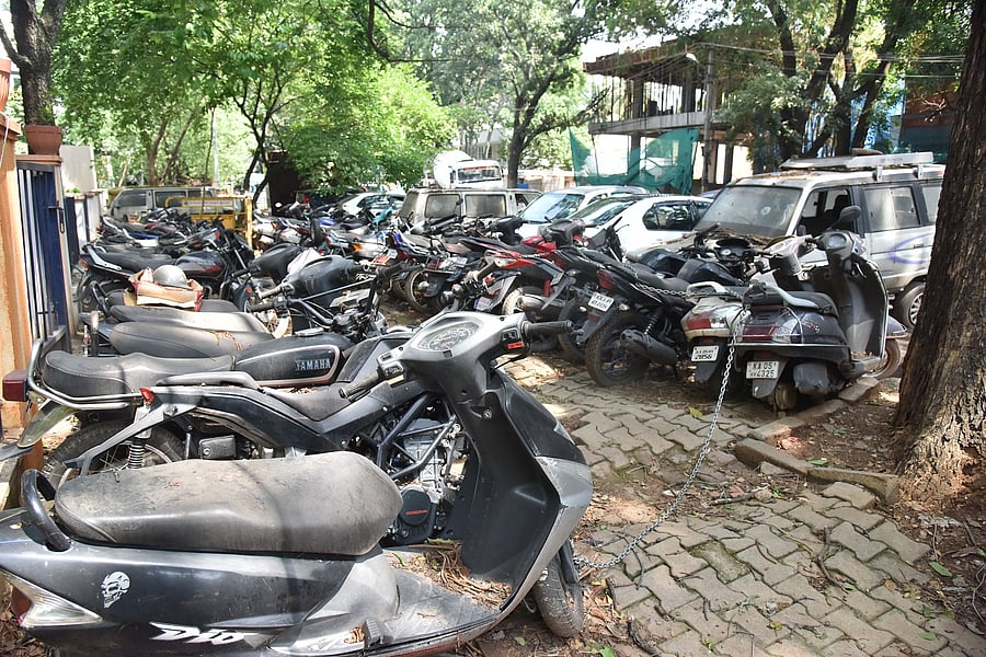 A large number of seized vehicles occupy footpaths near the Jayanagar police station, obstructing pedestrian movement. DH PHOTO BY B K JANARDHAN