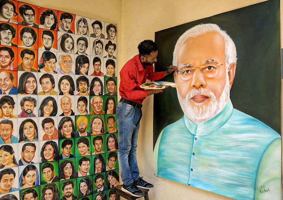 An artist adds details to a portrait of Prime Minister Narendra Modi ahead of his swearing-in ceremony for the second term as Prime Minister of India, in Amritsar, Wednesday, May 29, 2019. (PTI Photo)