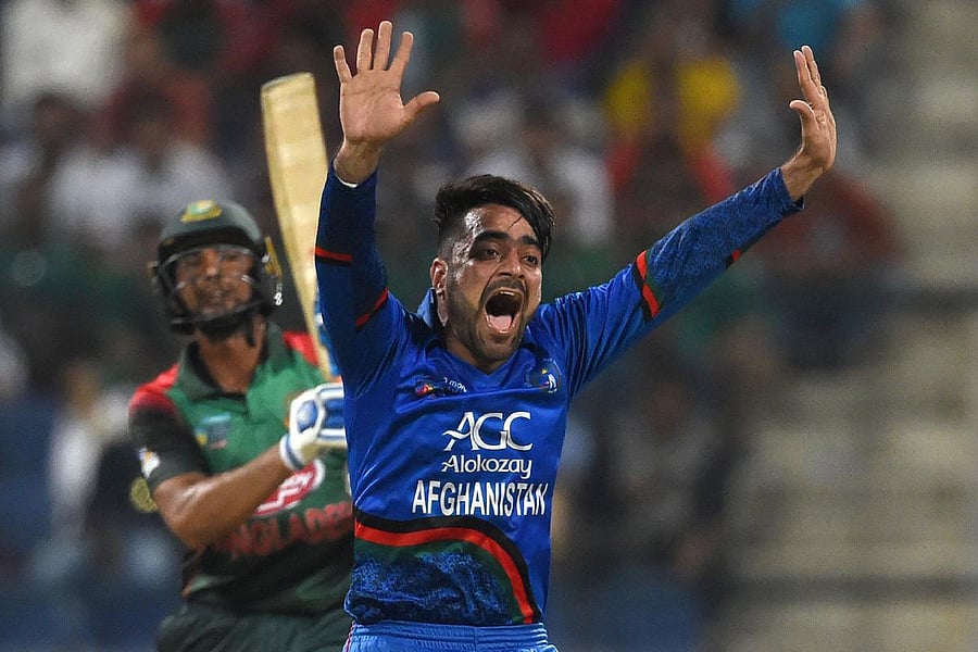(FILES) In this file photo taken on September 20, 2018 Afghan cricketer Rashid Khan appeals for an unsuccessful leg before wicket (LBW) decision against Bangladesh batsman Mohammad Mahmudullah during the one day international (ODI) Asia Cup cricket match