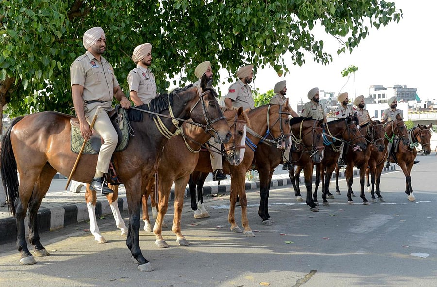 Indian Punjab Police personnel ride horses to patrol on the streets on the eve of the 35th Operation Blue Star Anniversary in Amritsar on June 5, 2019. - The Indian military's June 1984 assault on the Golden Temple in Amritsar, called Operation Blue Star, was aimed at flushing out militants holed up inside demanding an independent Sikh homeland.  AFP photo