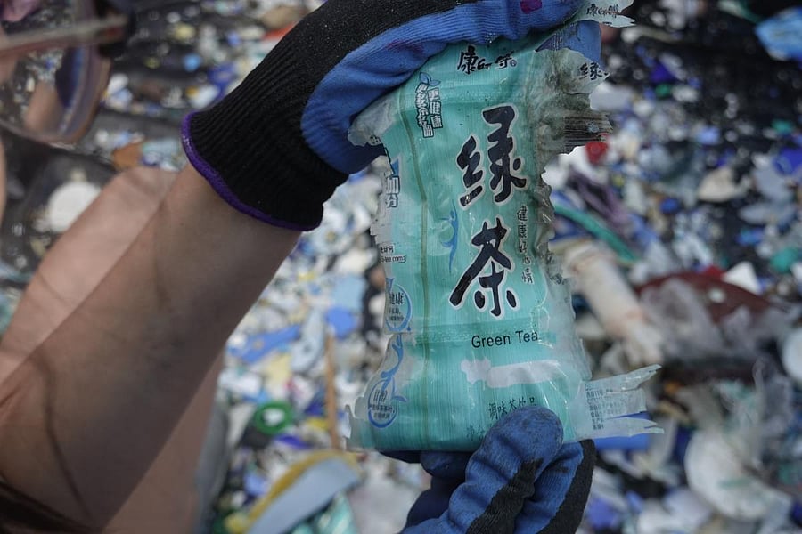 A volunteer shows a green tea label collected in the coast of Isabela Island in the Galapagos archipelago in the Pacific Ocean, 1000 km off the coast of Ecuado. AFP File photo