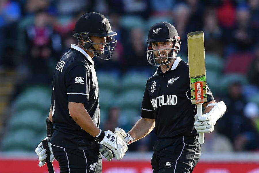TOP-NOTCH: New Zealand's captain Kane Williamson (right) celebrates with Ross Taylor after reaching his half-century against Afghanistan. AFP