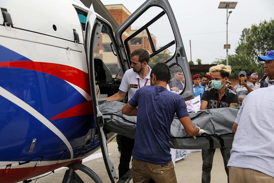 In this picture taken on 23 May, 2019, Nepali officials unload bodies of Everest climbers who died in previous seasons, at the helipad of Teaching Hospital in Kathmandu, Nepal. AFP