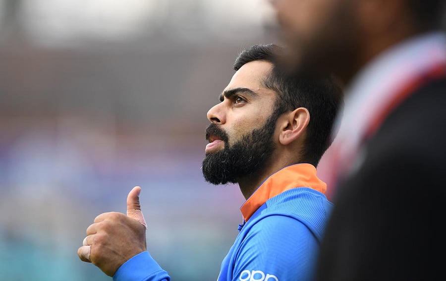 India's captain Virat Kohli gestures after victory in the 2019 Cricket World Cup group stage match between India and Australia at The Oval in London on June 9, 2019. (Photo by Adrian DENNIS / AFP)