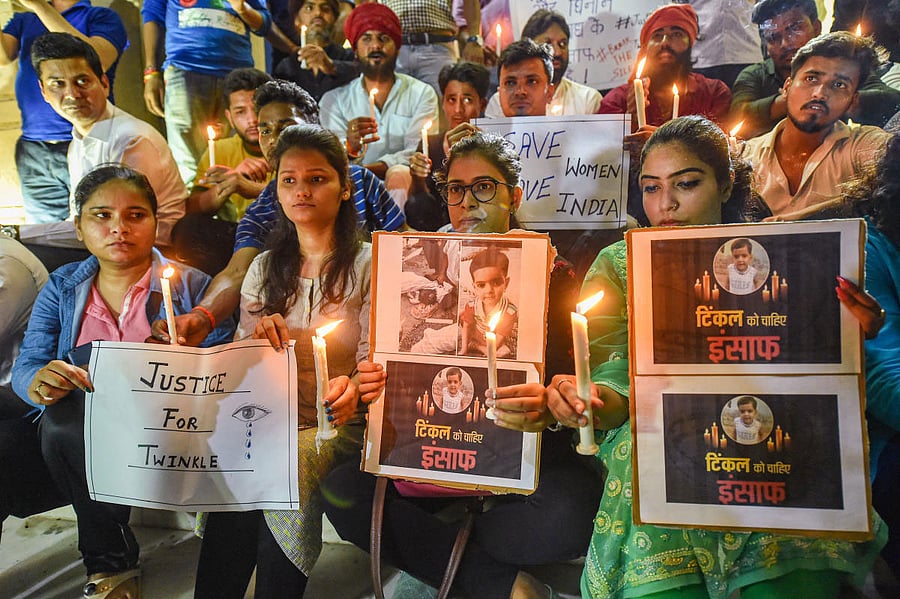 Lucknow University students participate in candle-march against killing of a girl in Aligarh, in Lucknow, Friday June 7, 2019. Five policemen, including an SHO, have been suspended for alleged negligence, five days after the mutilated body of a three-year-old girl was found in a garbage dump, triggering a huge public outcry over the brutality of the murder. (PTI Photo)