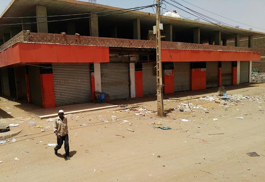 A man walks in front of closed shops in the Sudanese capital Khartoum on June 11, 2019, the third day of a nationwide civil disobedience campaign called to pressure the ruling military into handing over power. (AFP Photo)